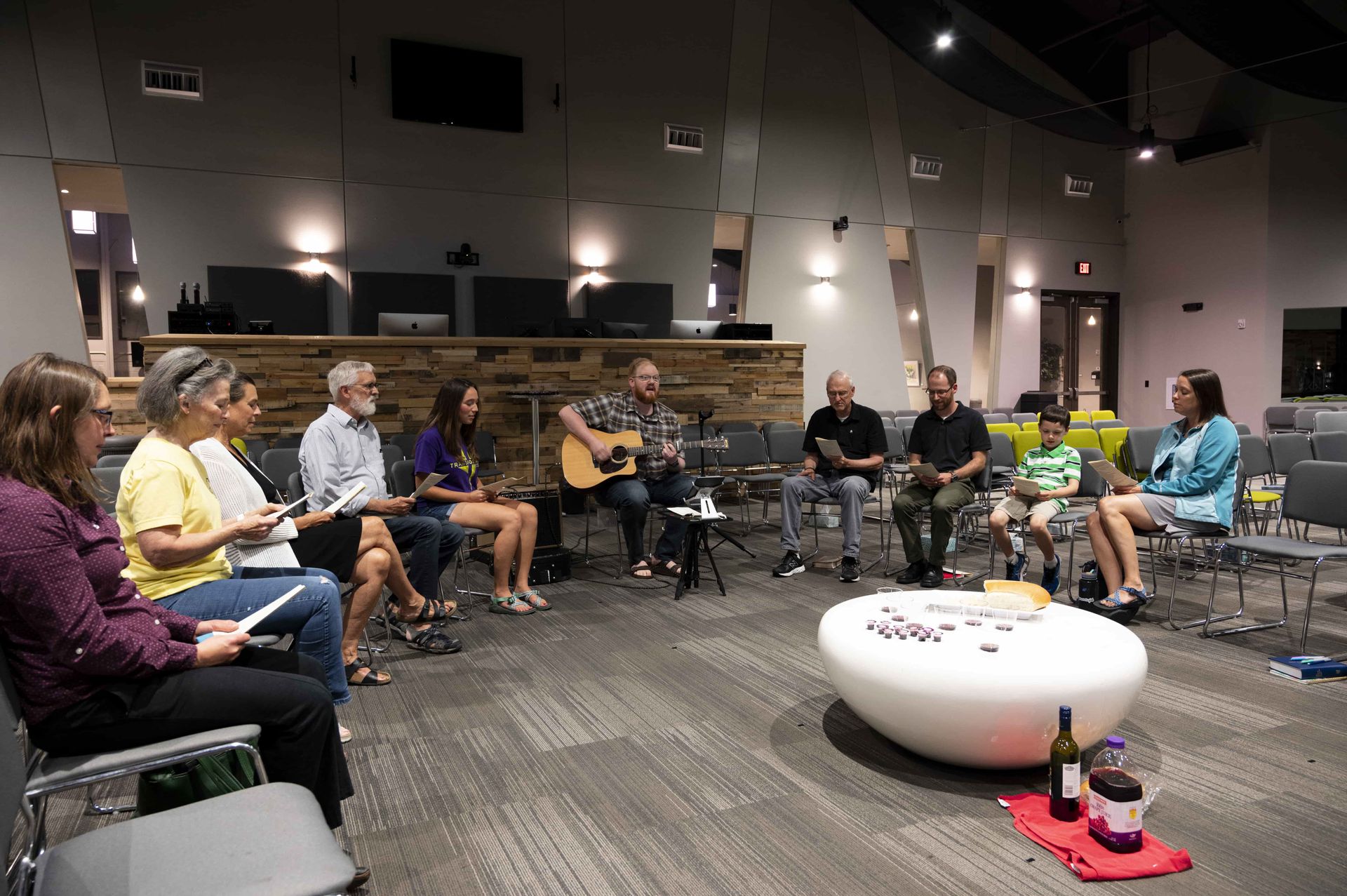 A group of people are sitting in a circle in a room.