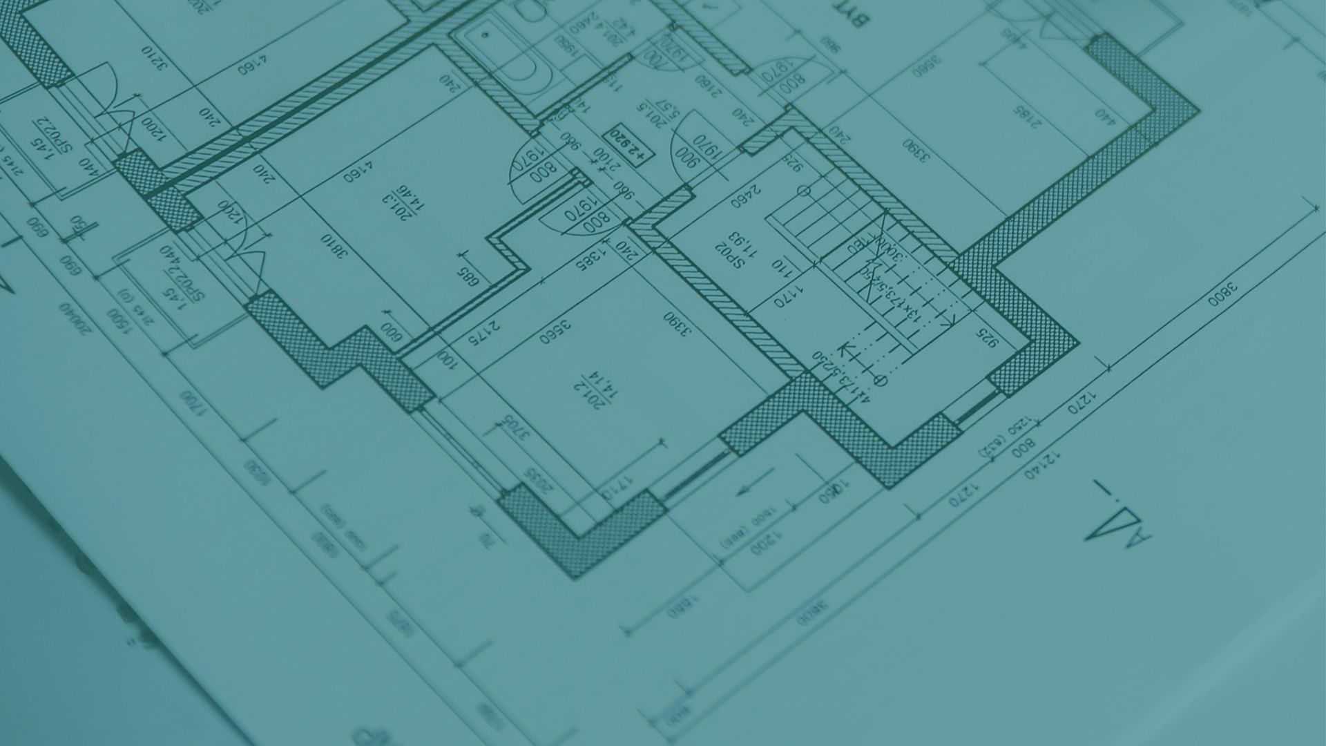 A blueprint of a house is laying on a table.