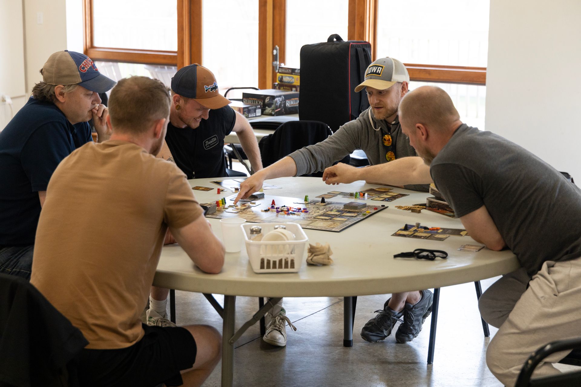 A group of men are sitting around a table playing a game.