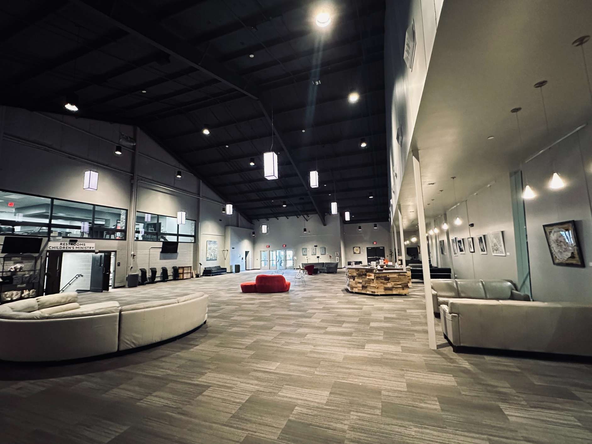 A large room with a lot of furniture and a clock on the wall.