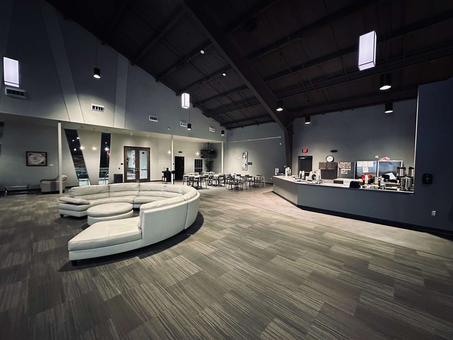 A large room with a couch and a counter in it.