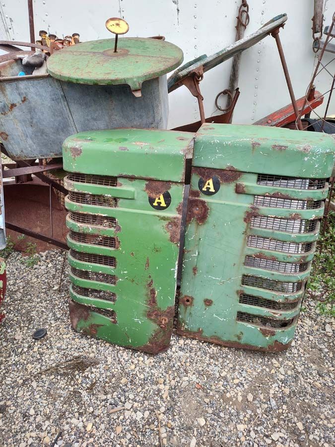 Two weathered, green tractor radiator grilles with 