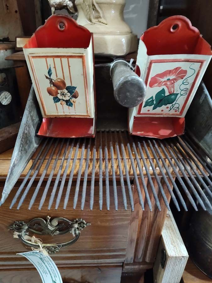 Antique seed separator with two painted containers and metal tines.