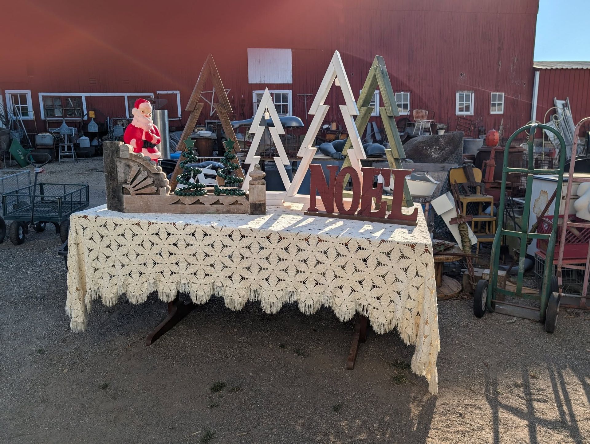Christmas decorations on a table at an outdoor market.