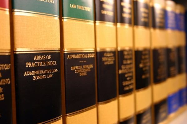 A row of law books including arias of practice index