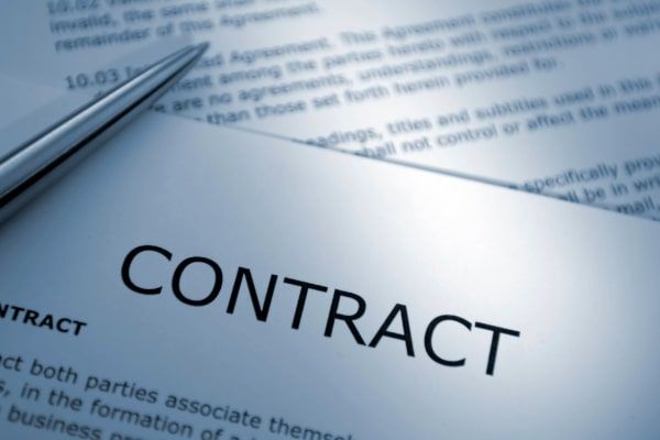 A pen is laying on top of a contract