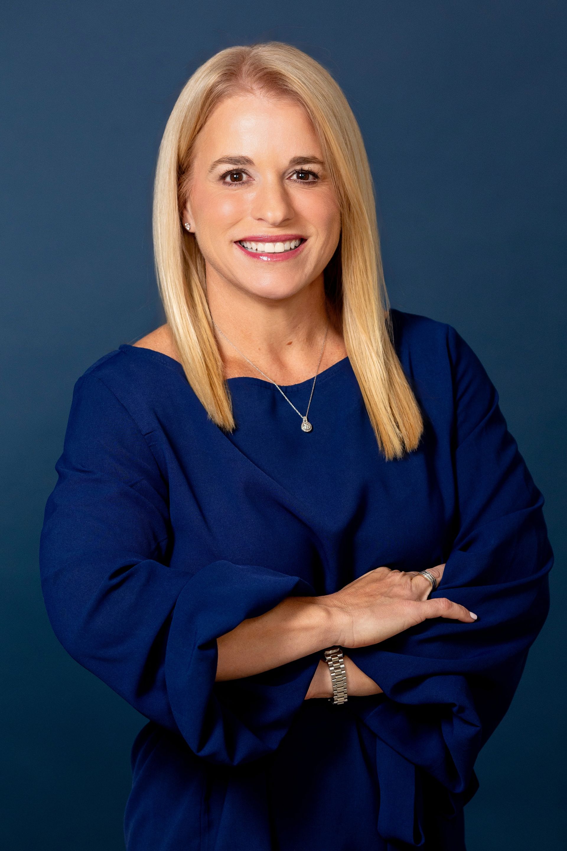 Marie Frances López in a black blazer against a gray background