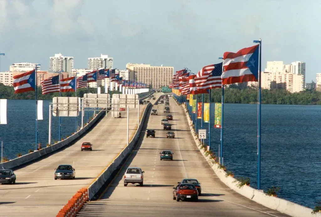 Carolina Puerto Rico Bridge with waving Puerto Rican and American flags