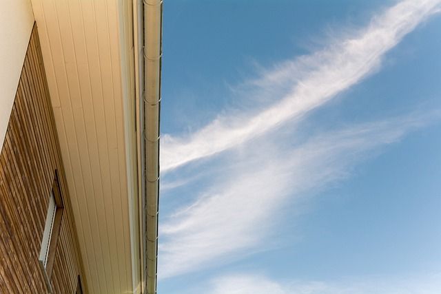 An underside view of a new gutter installation on an apartment complex in downtown Anchorage Alaska. 