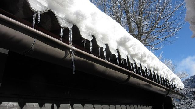 A sheet of icy snow ready to slide off rooftop in Anchorage Alaska. 