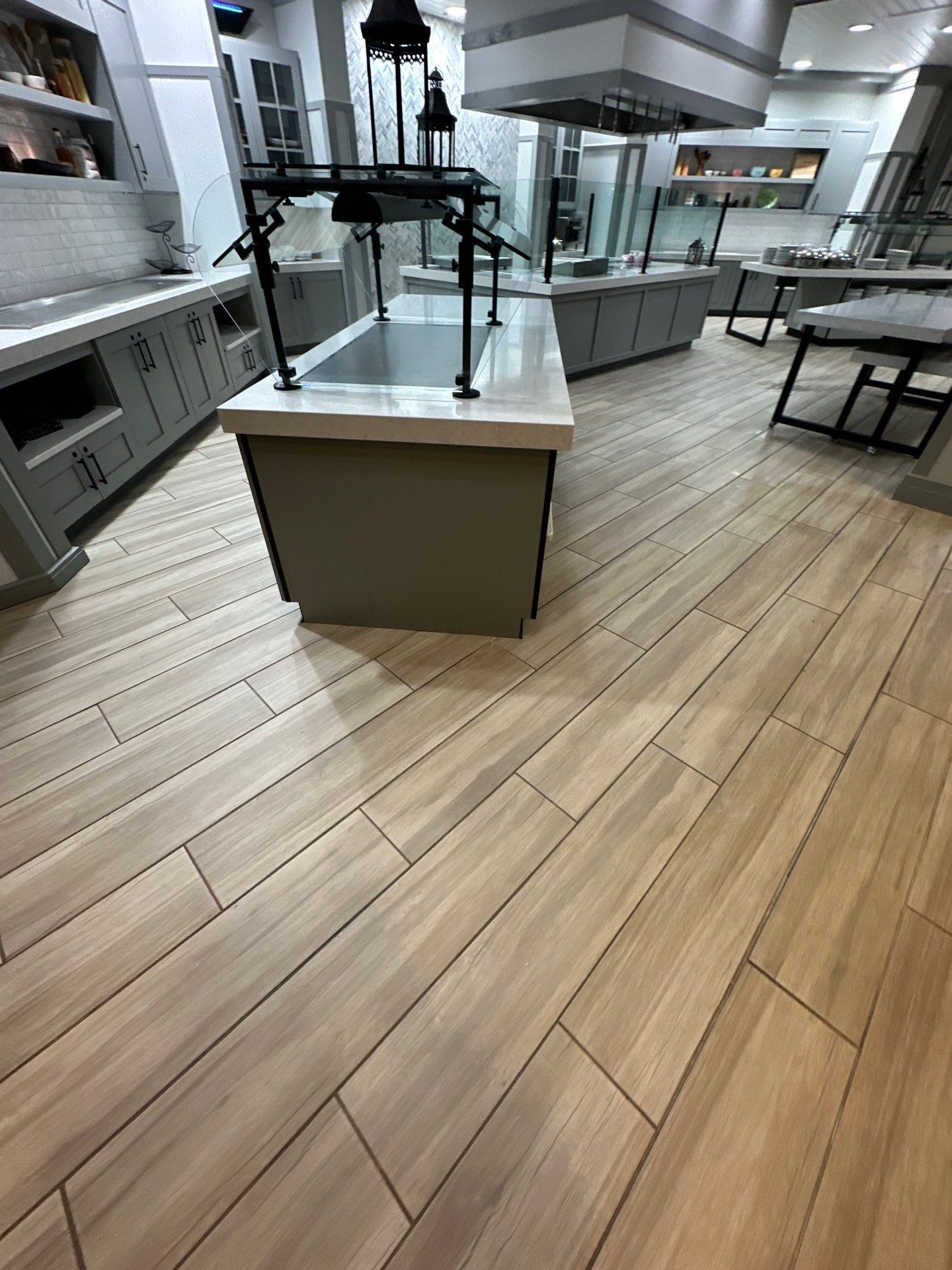 A kitchen with wooden floors and a large sink.