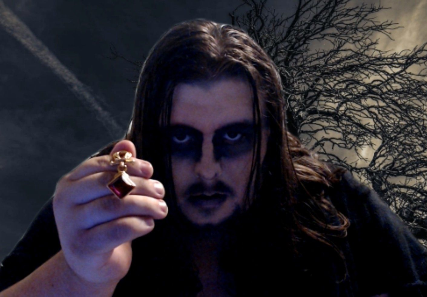 A man with black paint on his face is holding something in his hand, representing Dream.