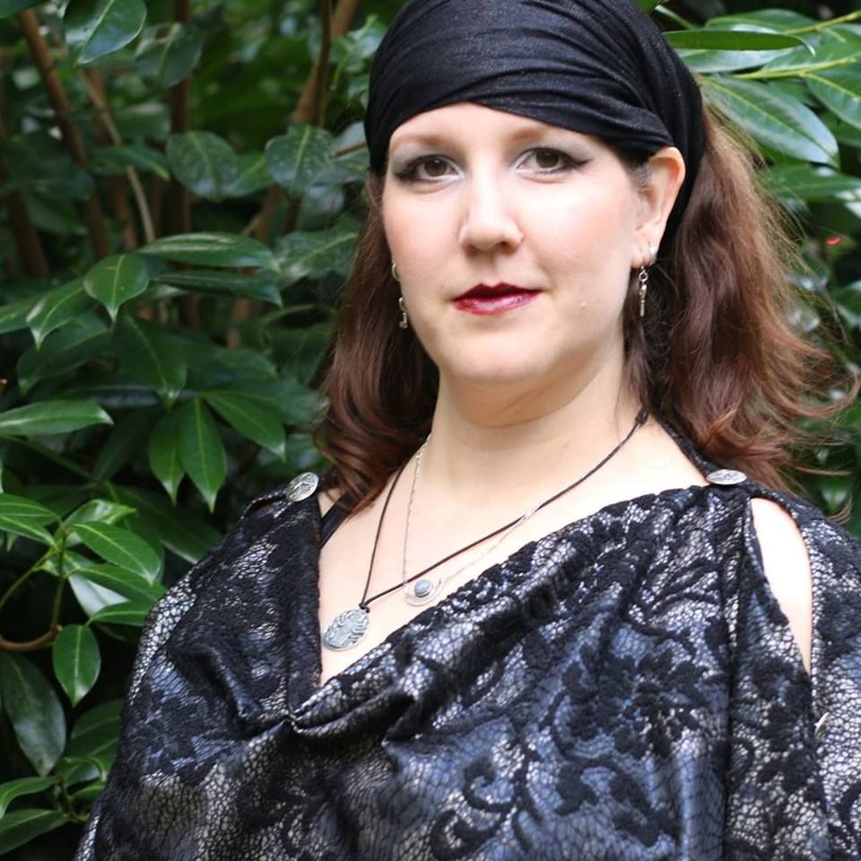 A bunch of keys are sitting on a wooden table.