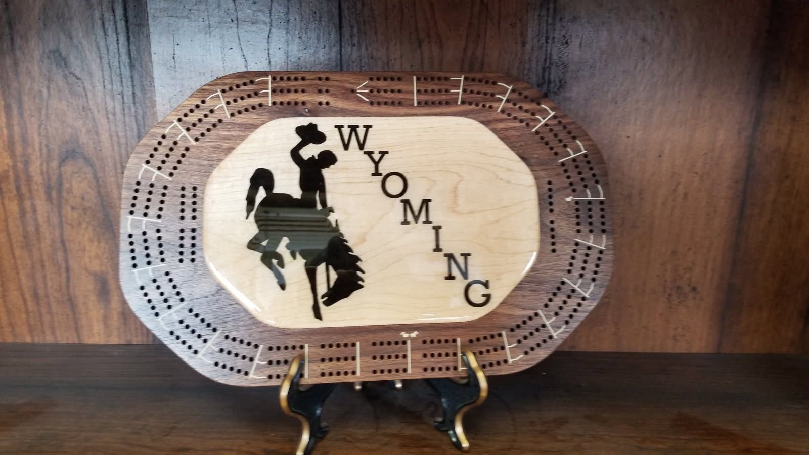 A wooden plate with the word wyoming on it