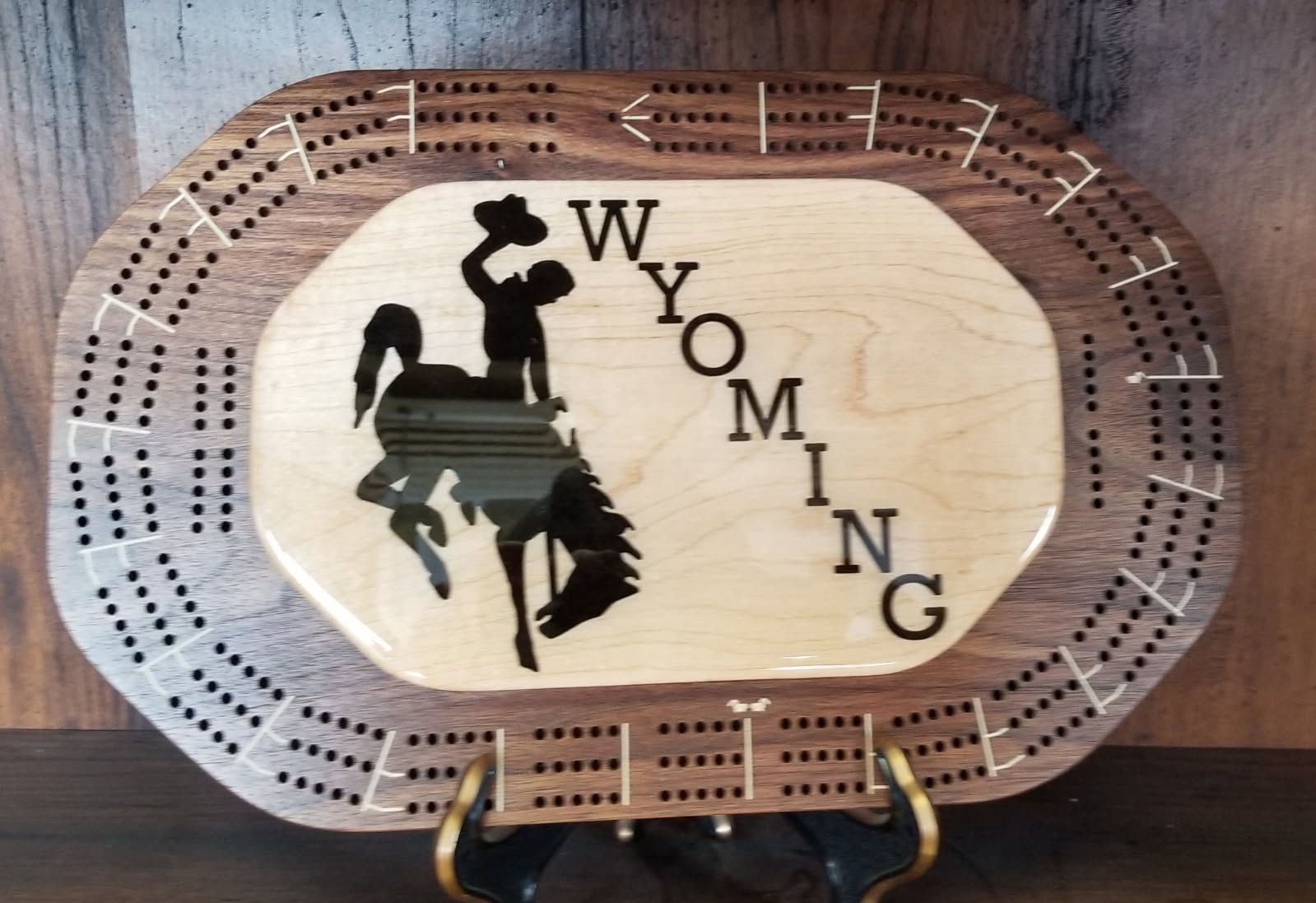 A wooden cribbage board with the word wyoming on it