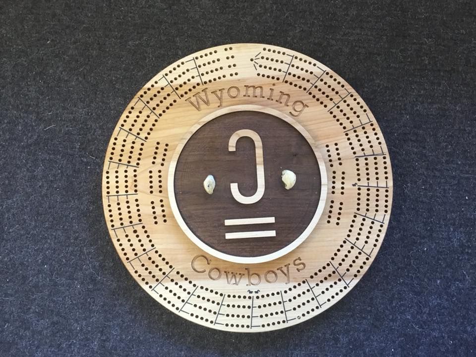 A wooden circle that says wyoming cowboys on it