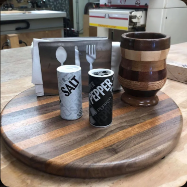 Salt and pepper shakers on a wooden cutting board