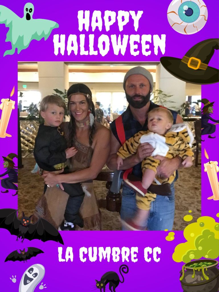 A happy halloween frame with a man and woman holding two children