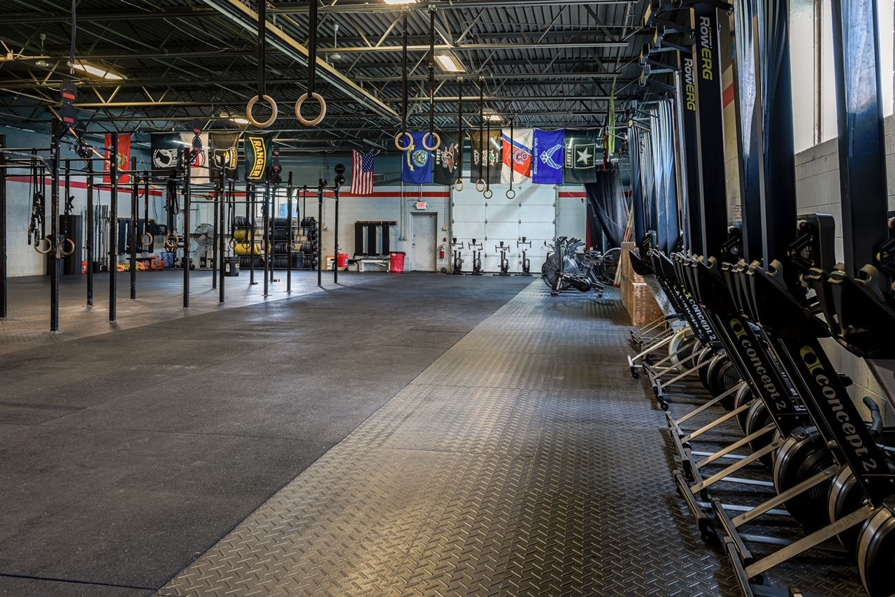 A large empty gym with a lot of exercise equipment.