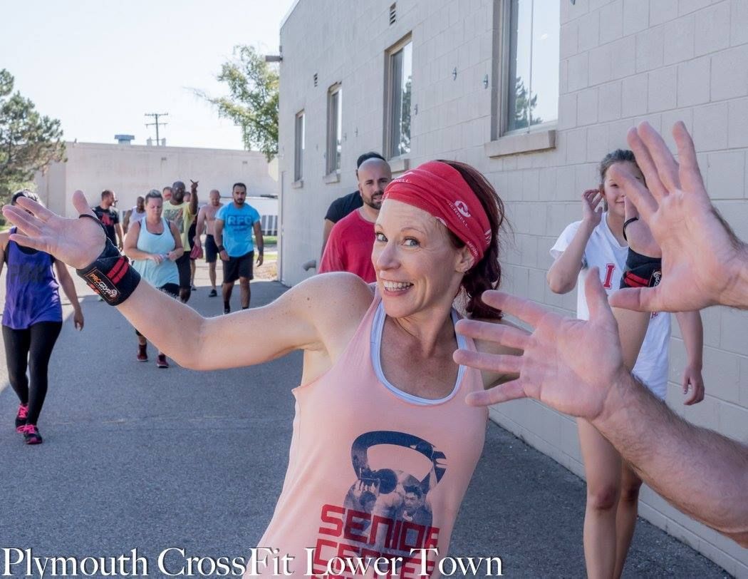 A woman wearing a shirt that says sense is giving a high five