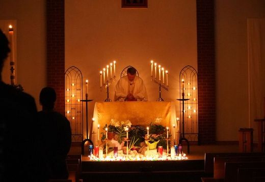 adoration of the blessed sacrament during a Easter catholic mass done in candle light