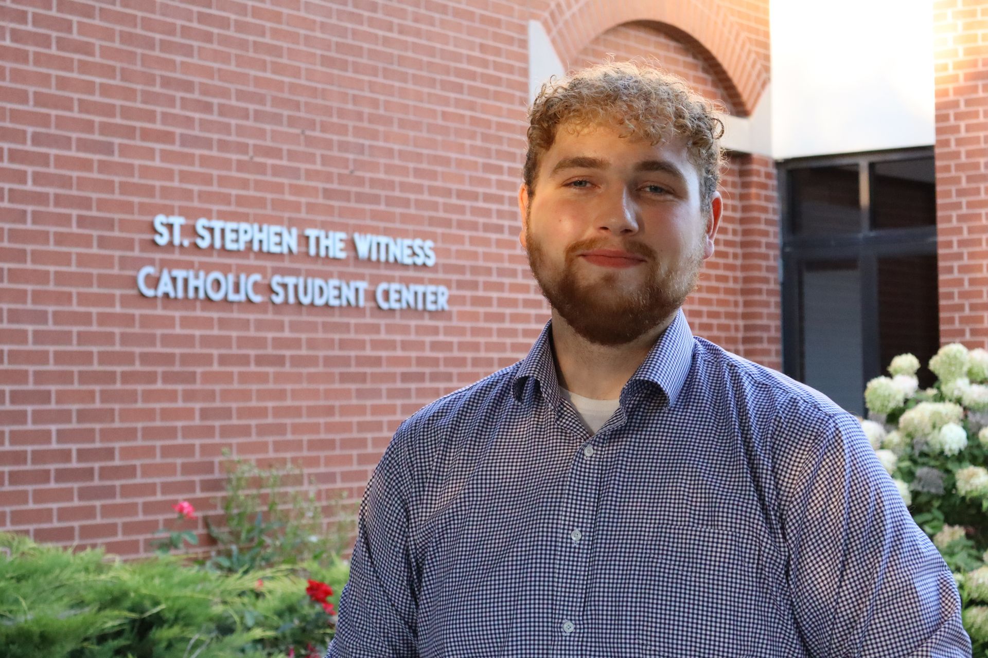 A man in a suit and tie is smiling for the camera.
