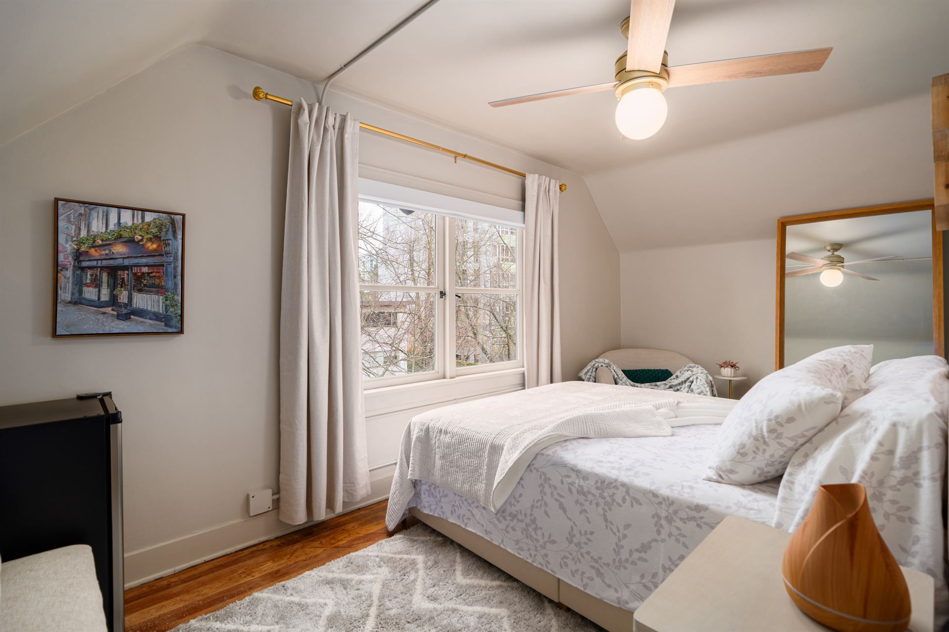 The shadow of a palm tree is cast on the sand on the beach.