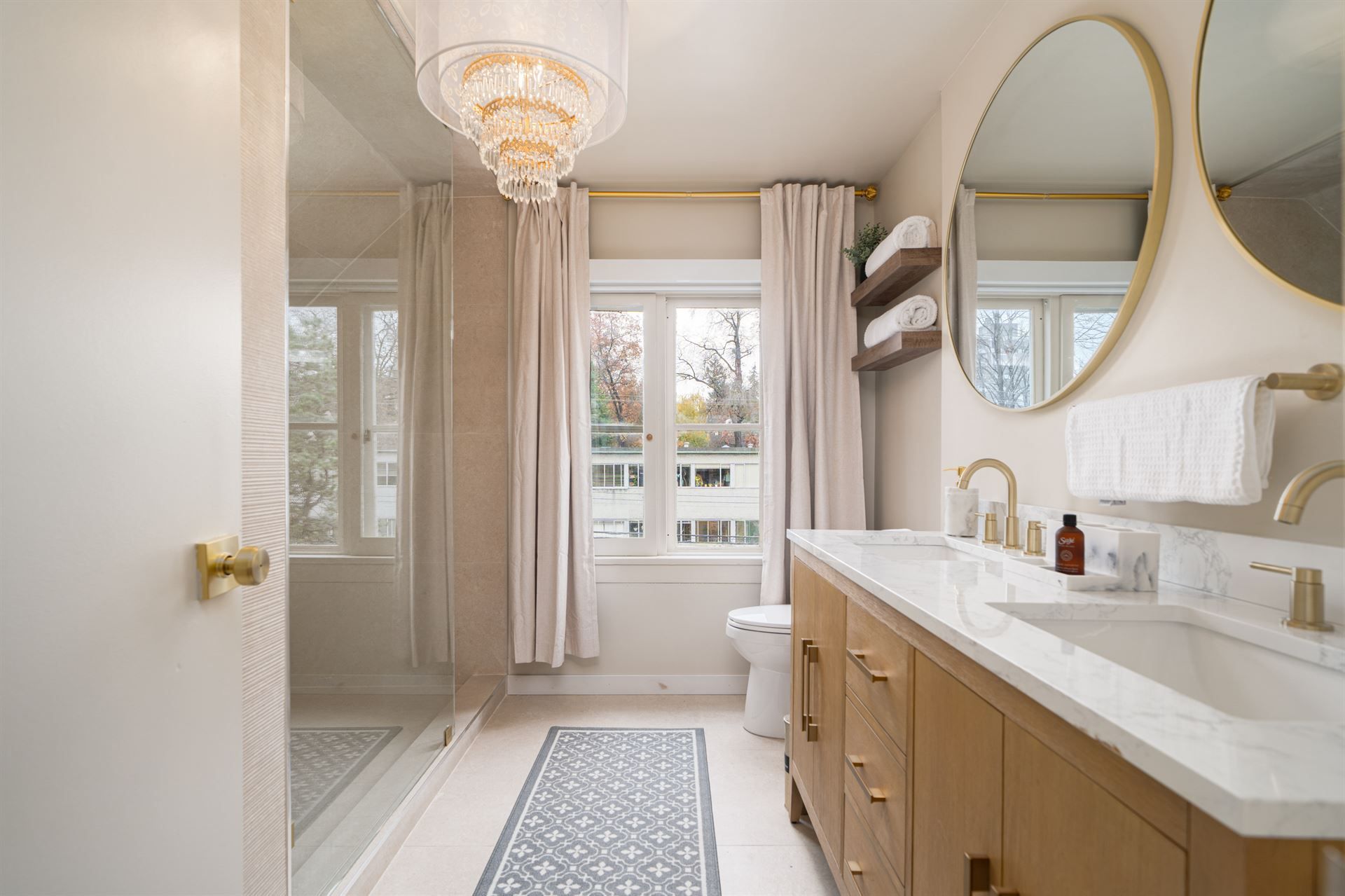 A bathroom with a sink , toilet , and mirrors.