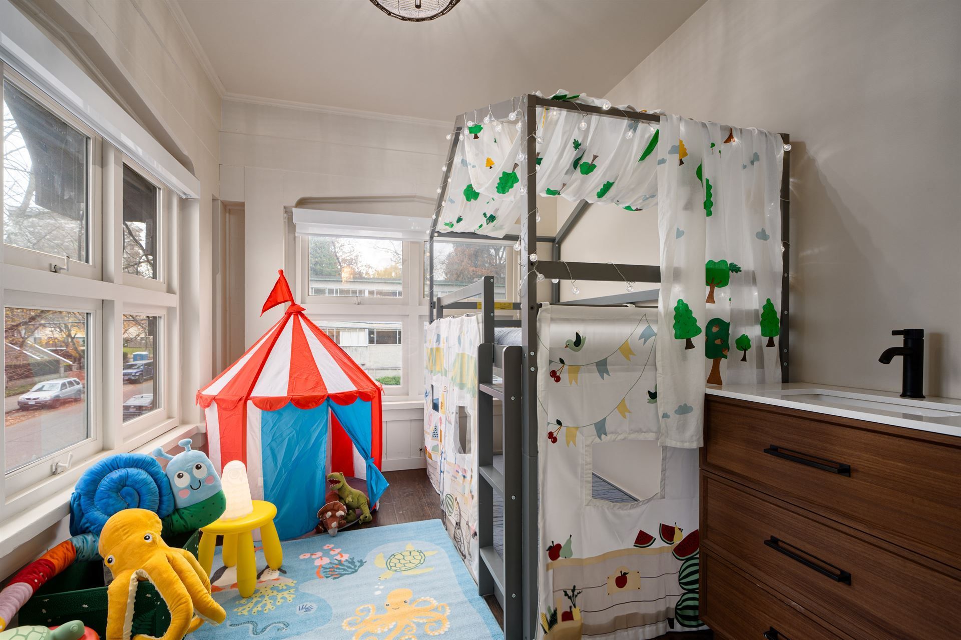 A child 's bedroom with a bunk bed and a tent.