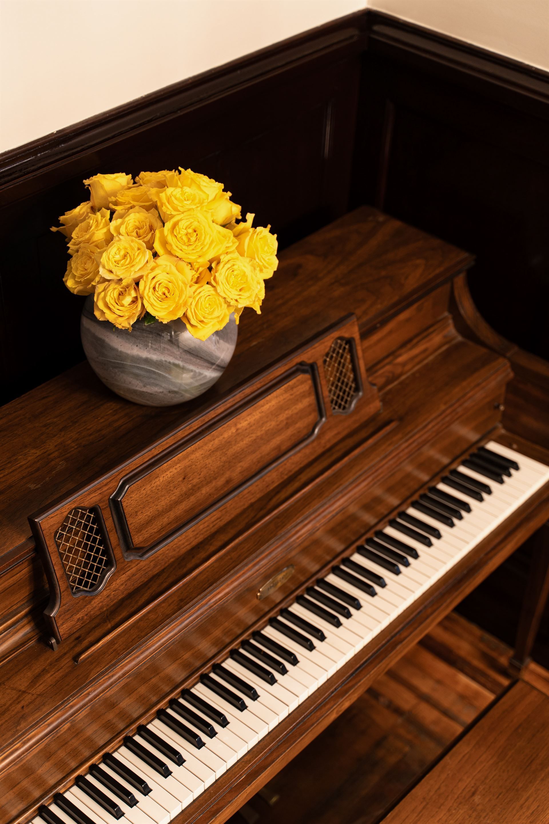 A person is petting a white dog wearing sunglasses