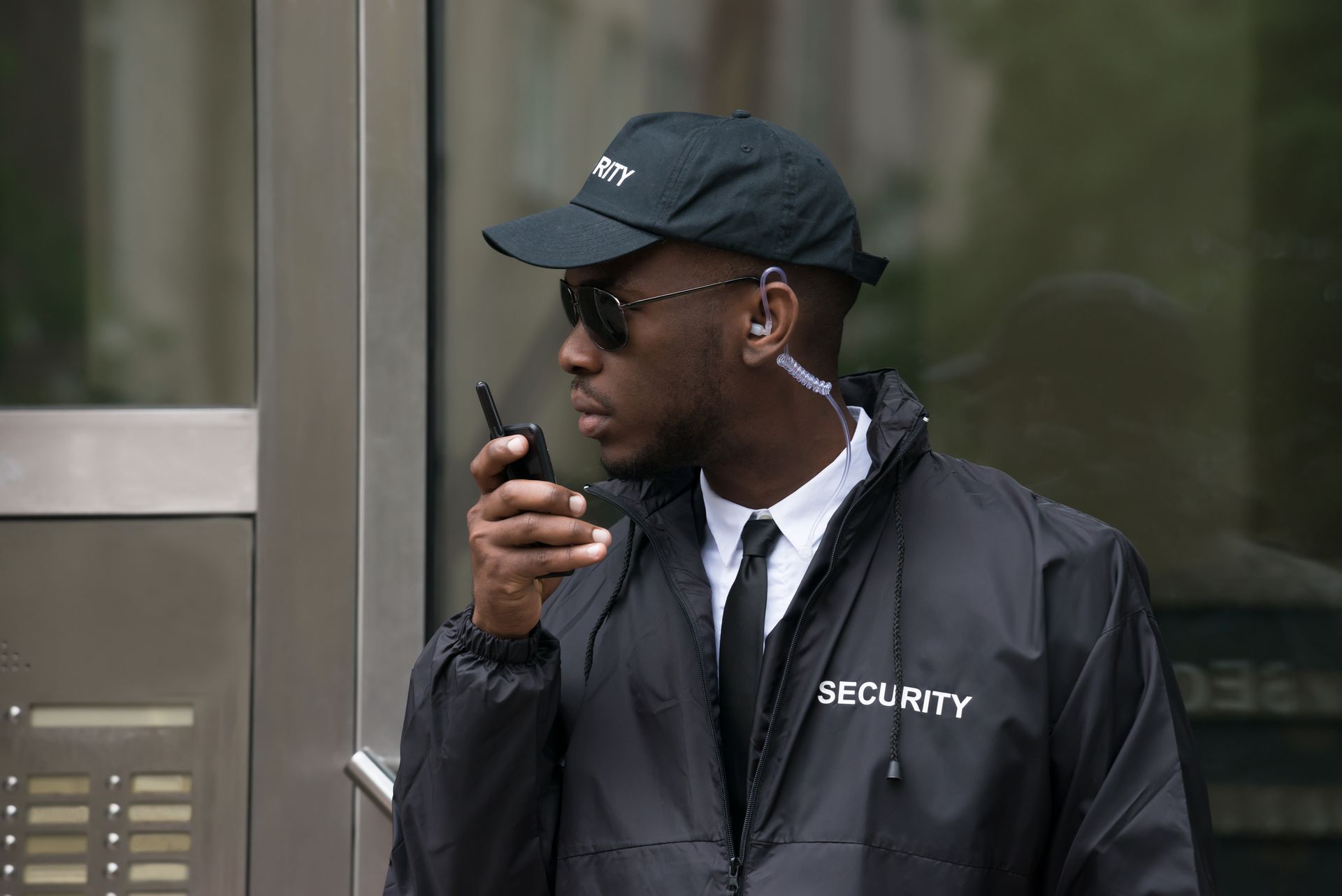 Security guard in black uniform and cap