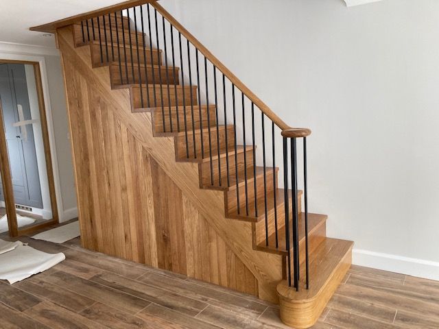 Modern cut string staircase with metal spindles