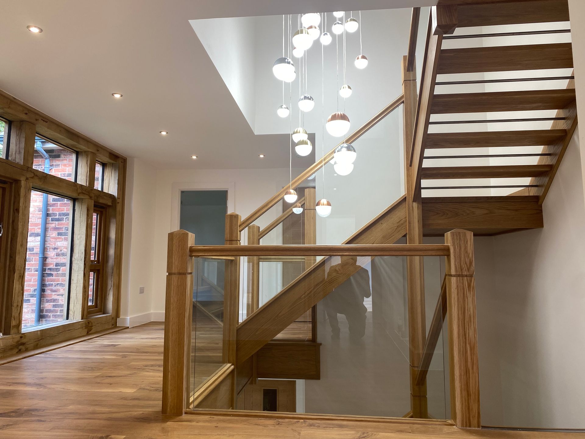 Open tread oak staircase with glass balustrade