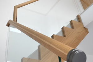 Bespoke staircase with continuous oak handrail