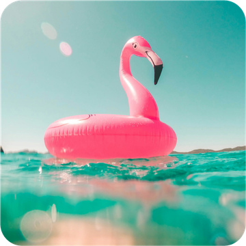 A pink flamingo float is floating in the ocean.