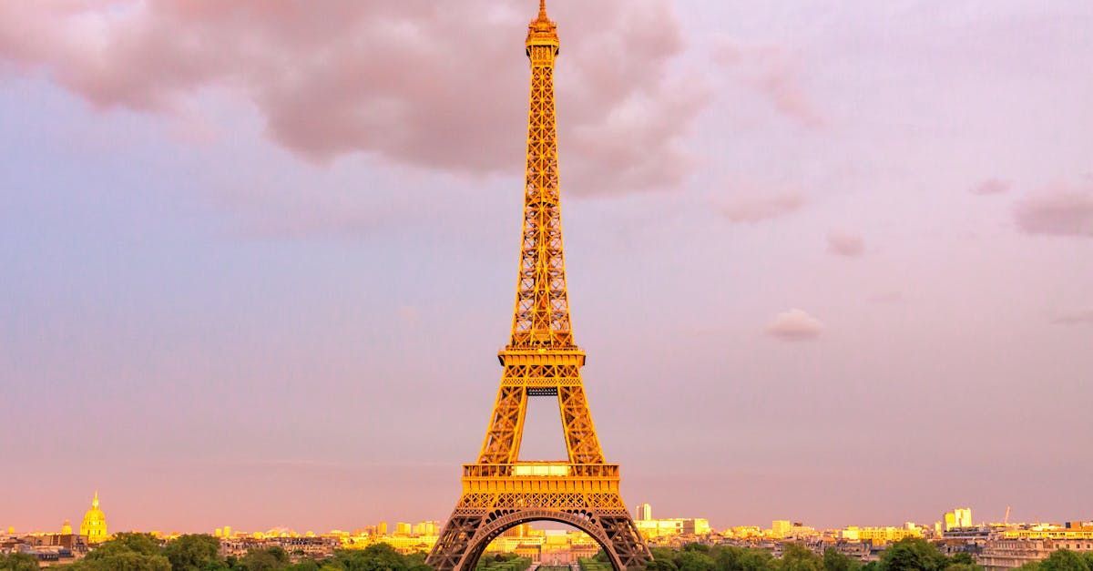 The eiffel tower is lit up at night in paris.