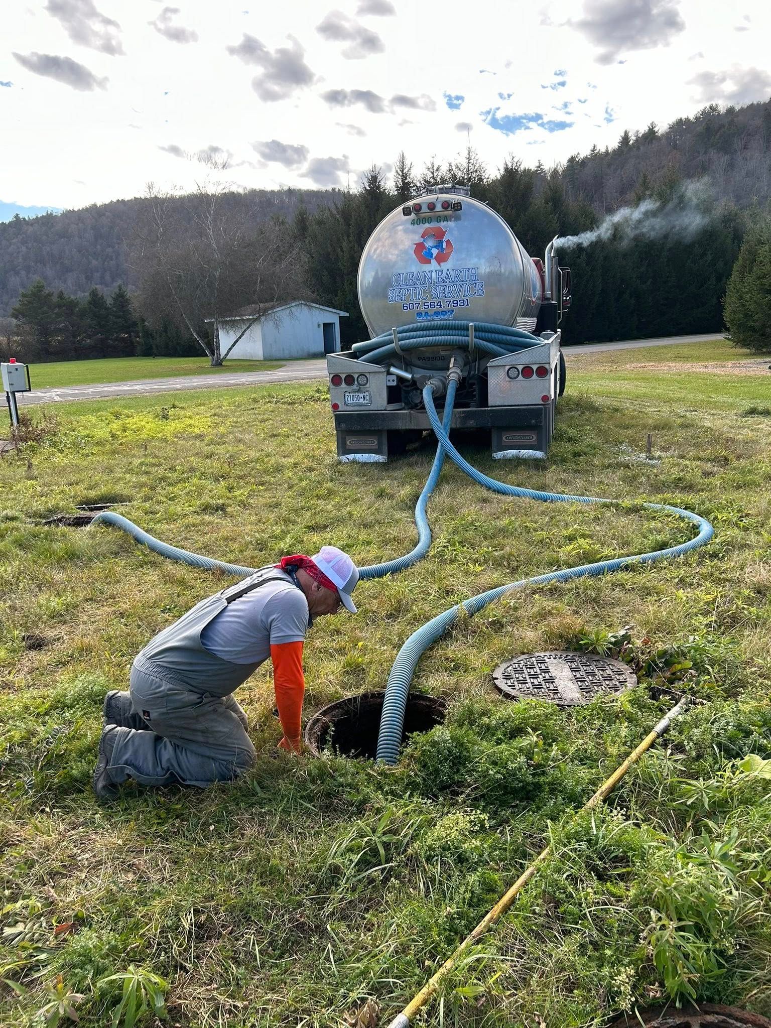 Septic technician inspecting tank in Ithaca, NY