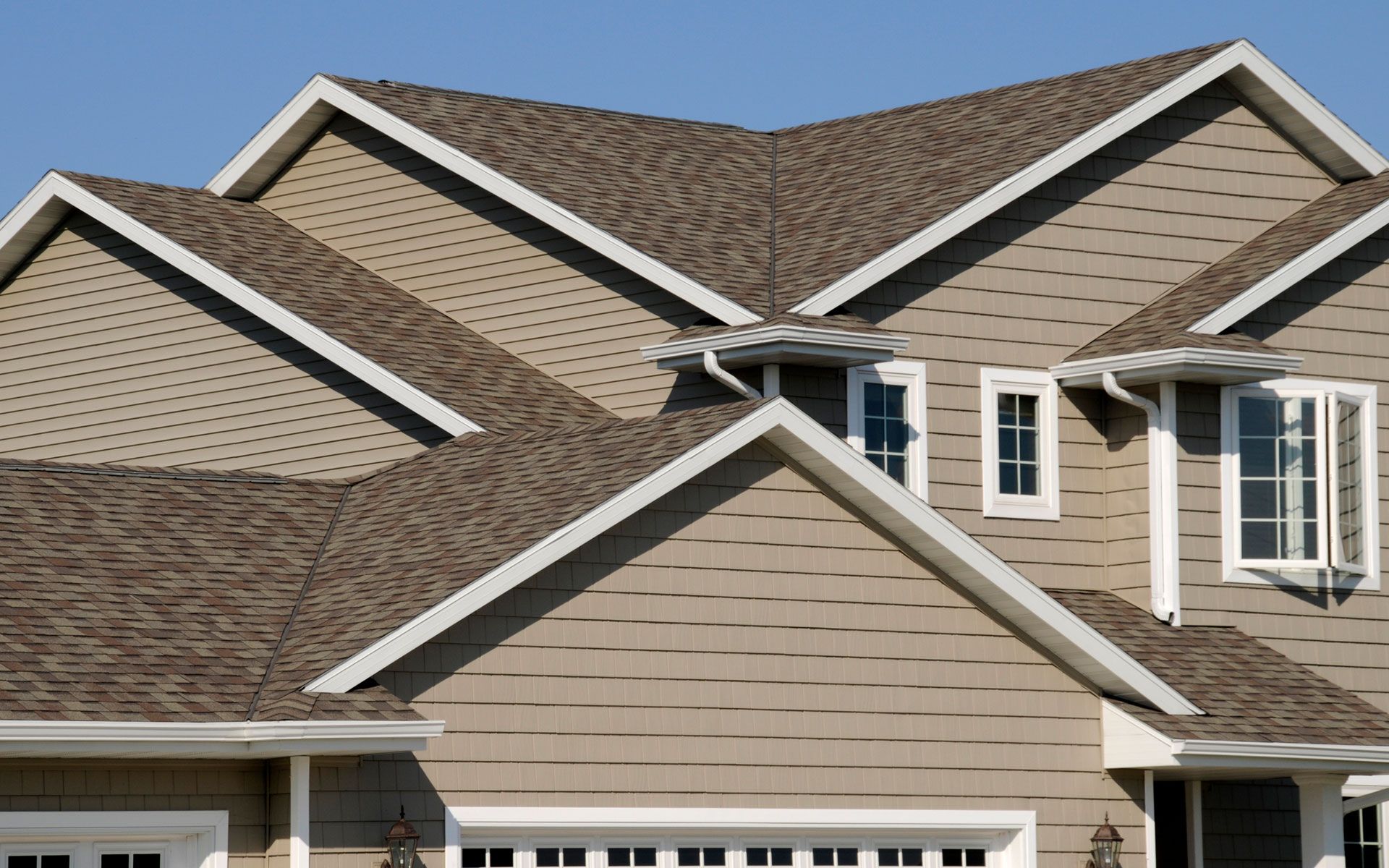 A house with a brown roof and white trim