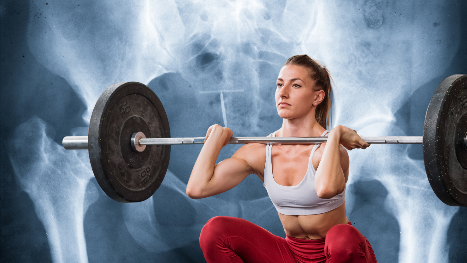 Woman lifting a barbell in a smoky gym, wearing a white top and red leggings.