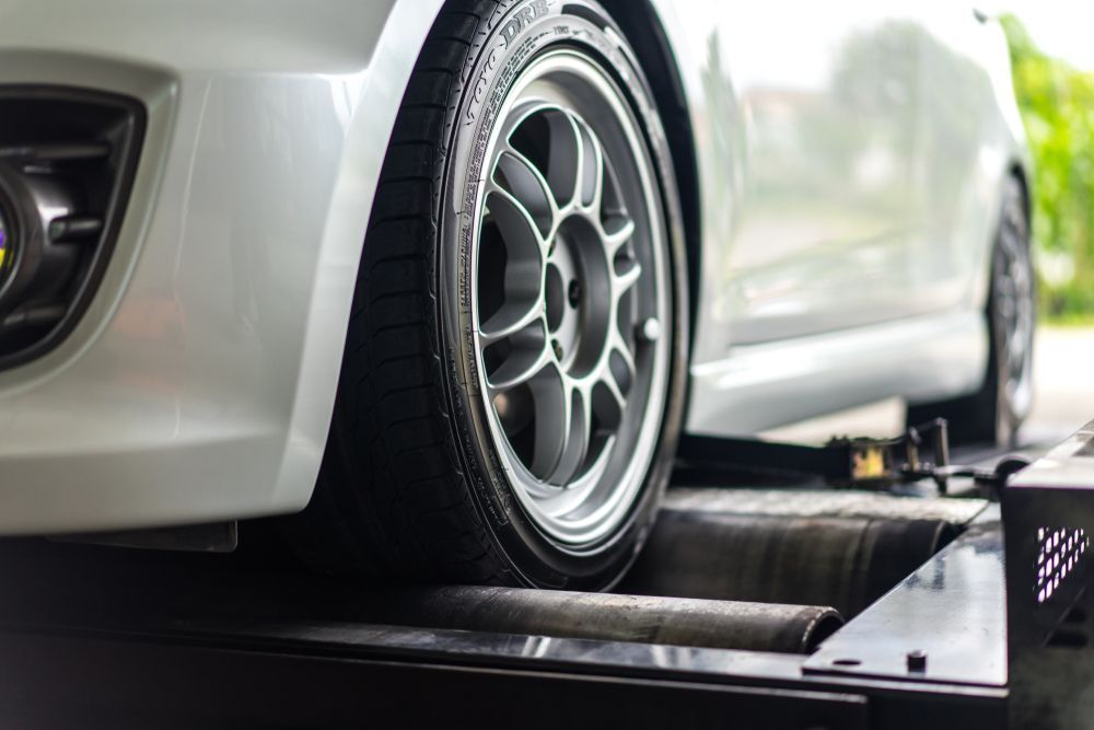 A White Car is Being Tested on a Machine — AVA Automotive Repairs in Oak Flats, NSW