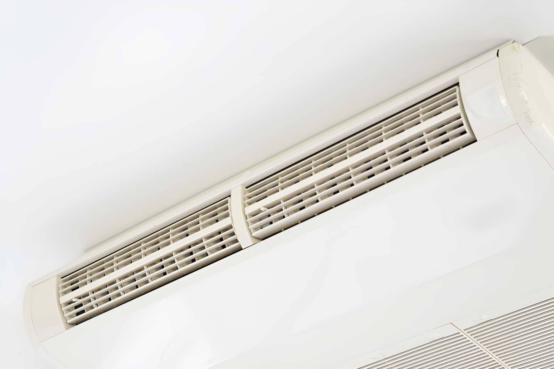 White Air Conditioner is Mounted to the Ceiling — Robbie McDonald Electrical in Sippy Downs, QLD