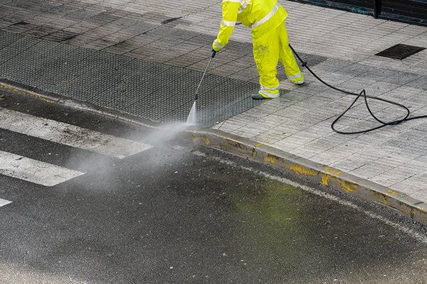 Worker Cleaning the Sidewalk with Pressurized Water — Myerstown, PA — Your Choice Specialties