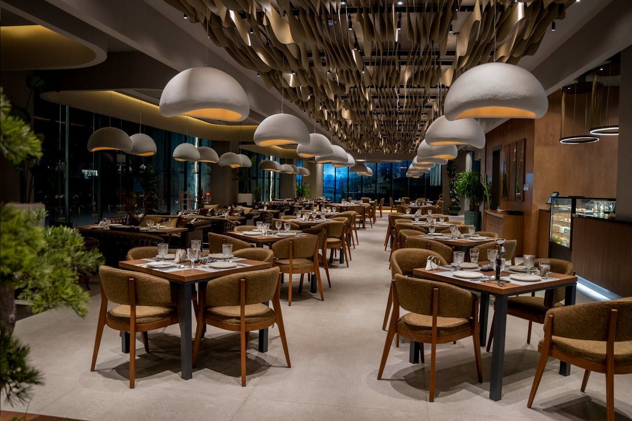 There are many tables and chairs in the restaurant.