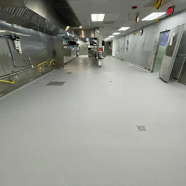 A high-gloss, clean epoxy floor in a residential garage, sparkling under the lights.