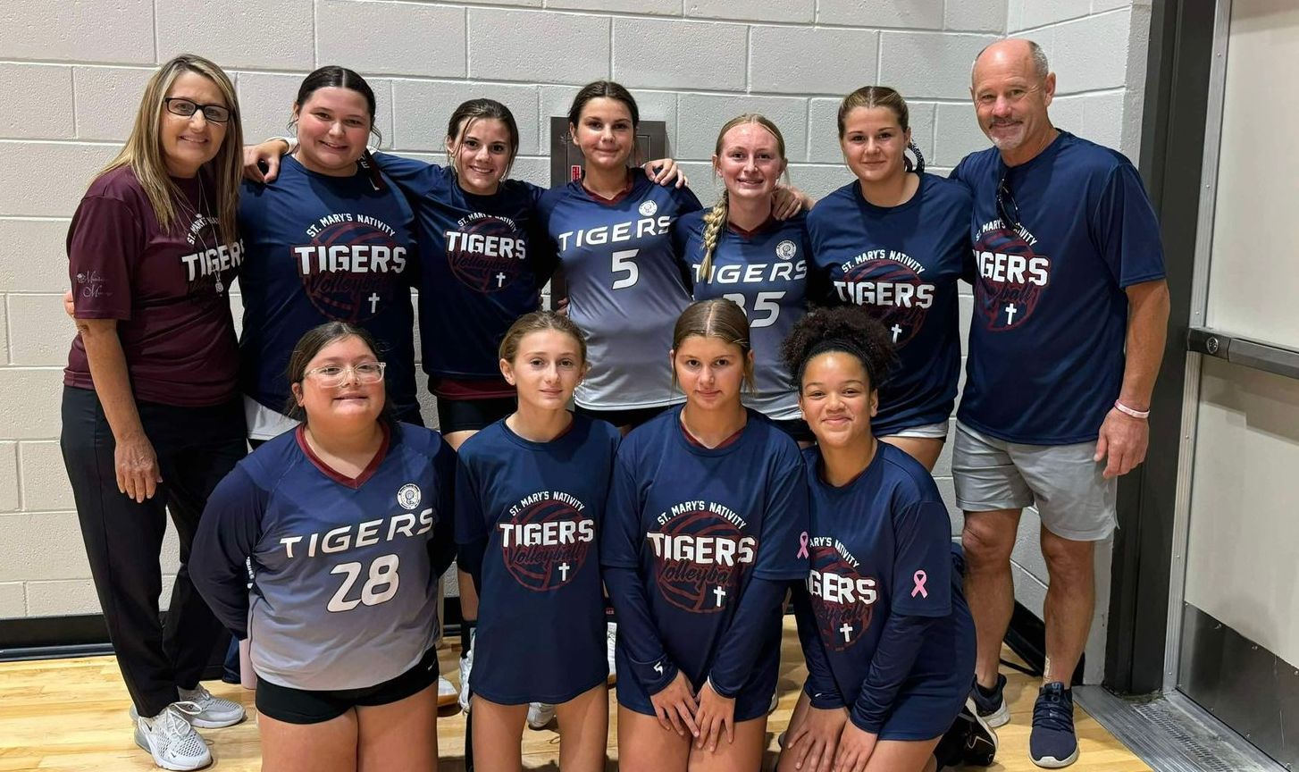 A girl running on a track wearing a tank top that says ' runner ' on it