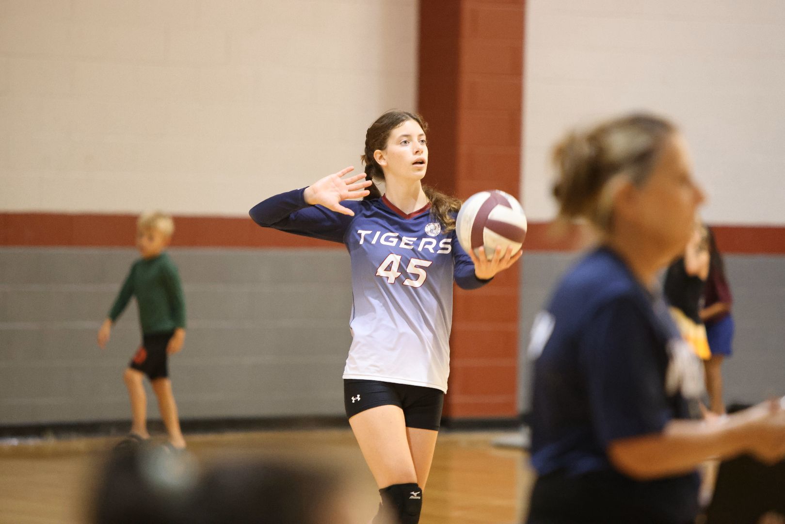 A volleyball player with the number 45 on her jersey