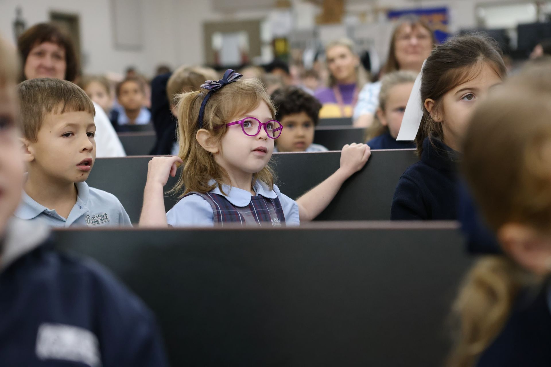 A girl running on a track wearing a tank top that says ' runner ' on it