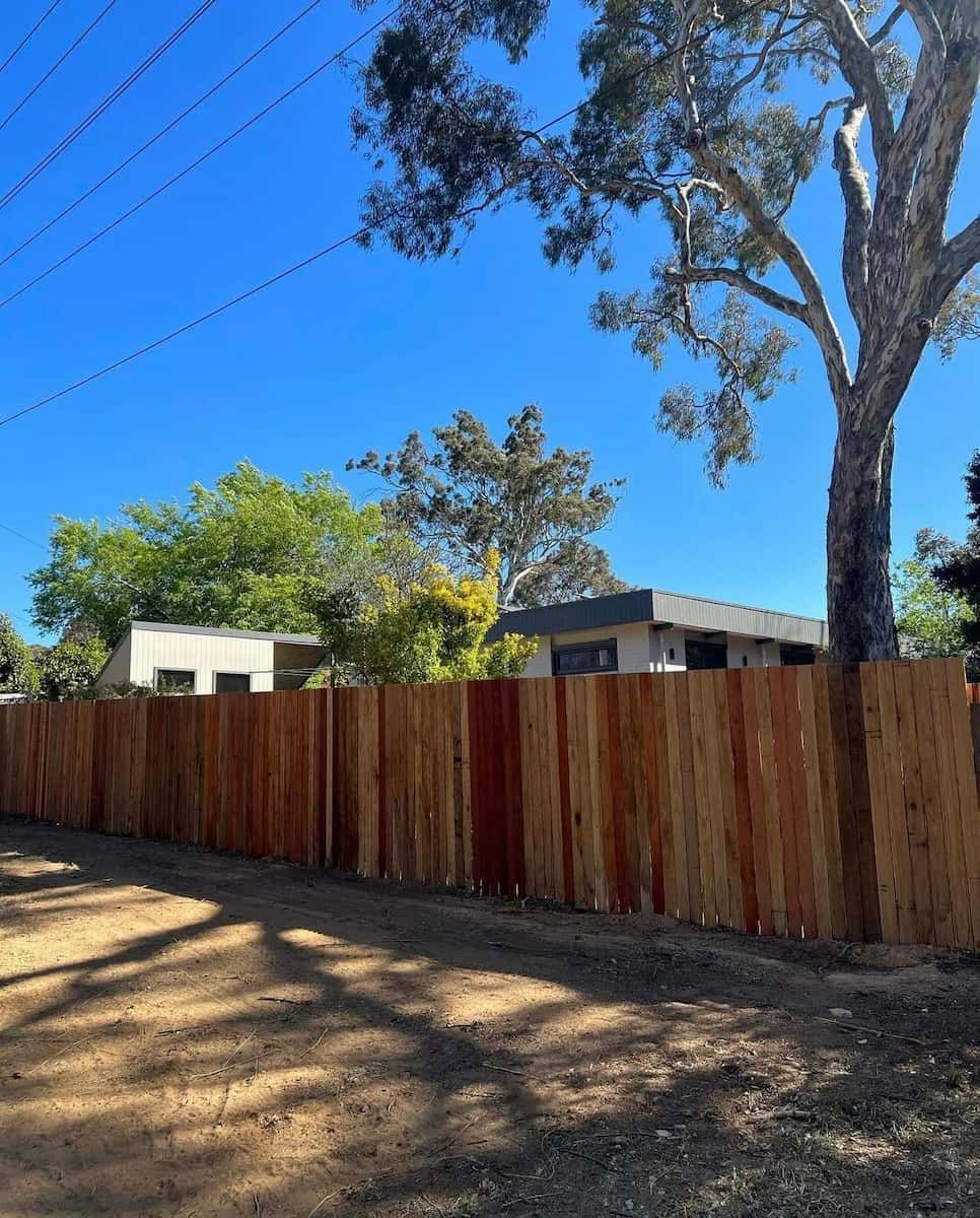 A Wooden Fence With a Tree in the Background — CLF Landscaping In Hawker, ACT