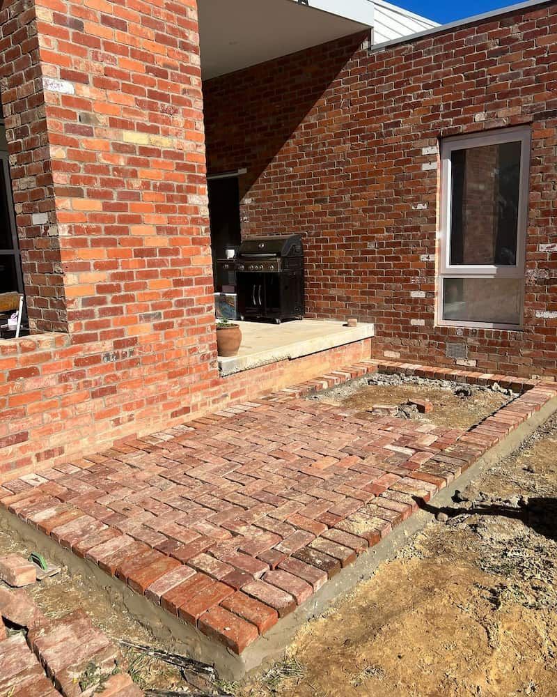 A Brick Building With a Brick Walkway in Front of It — CLF Landscaping In Hawker, ACT