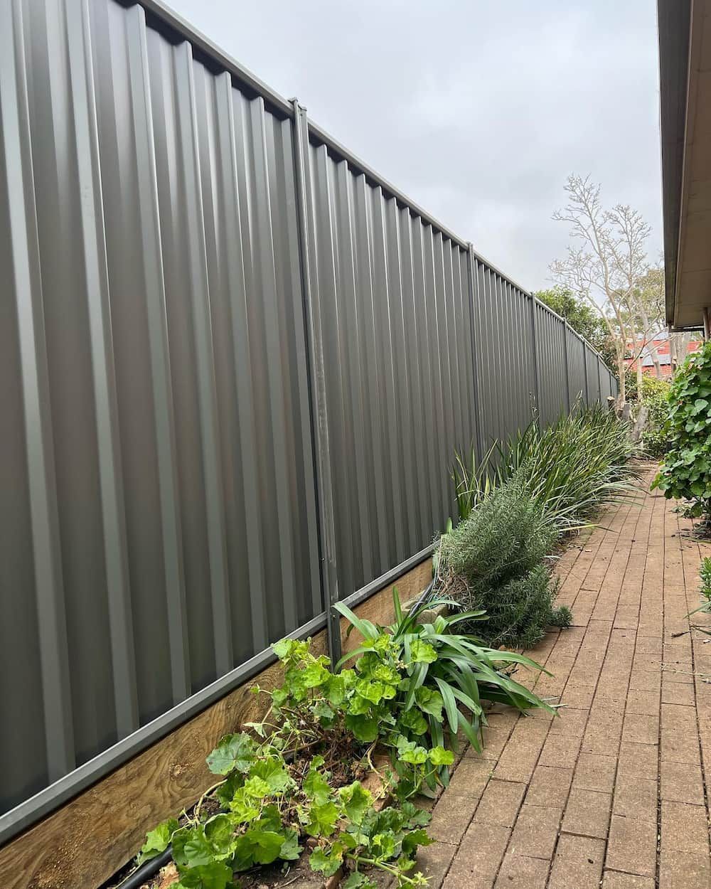 There is a Fence Along the Side of a Brick Walkway — CLF Landscaping In Hawker, ACT